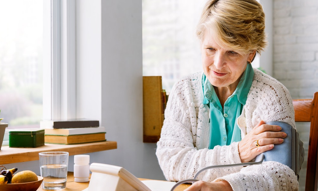 old woman checking blood pressure