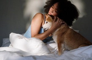 black woman hugging dog